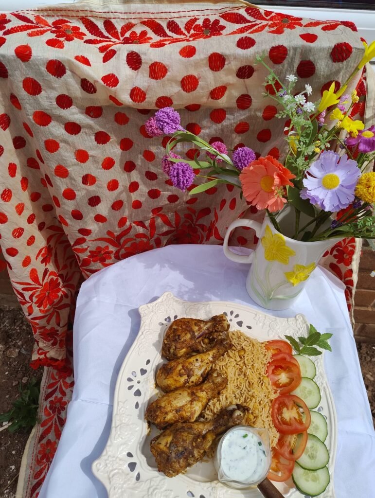 Air fryer chicken drumsticks plated over rice with styled garnish and dip